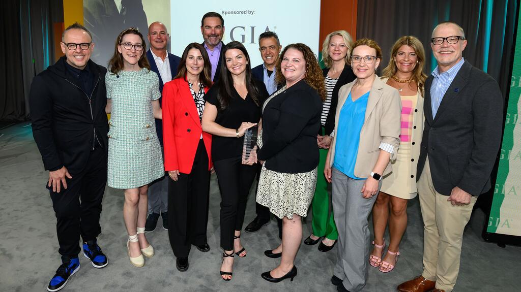 Jewelers Mutual’s Krystle Craycraft, center, is pictured holding the Sallie Morton Award, surrounded by members of the Jewelers Mutual team. 20240425_Sallie Morton Award winners.jpg